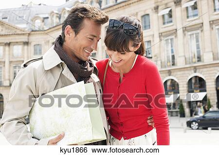Stock Photograph - Couple smiling on a street, Paris, Ile-de-France, France. Fotosearch