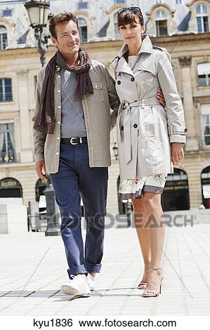 Stock Photograph - Couple walking on a street, Paris, Ile-de-France, France. Fotosearch