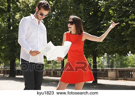 Man reading a map with a woman pointing, Terrasse De l'Orangerie, Jardin des Tuileries, Paris, Ile-de-France, France View Large Photo Image Stock Image - Man reading a map with a woman pointing, Terrasse De l'Orangerie, Jardin des Tuileries, Paris, Ile-de-France, France. Fotosearch