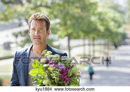Picture - Man with a bouquet of flowers, Paris, Ile-de-France, France. Fotosearch