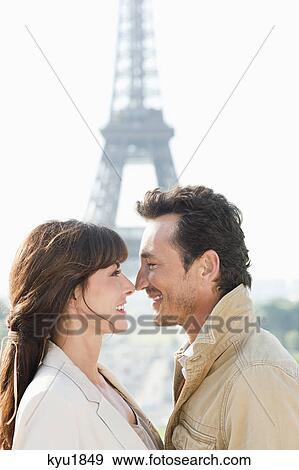 Stock Photo - Romantic couple with the Eiffel Tower in the background, Paris, Ile-de-France, France. Fotosearch