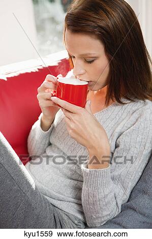Stock Photo - Young woman drinking coffee. Fotosearch