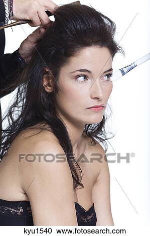 Young woman getting her hair done View Large Photo Image Stock Image - Young woman getting her hair done. Fotosearch