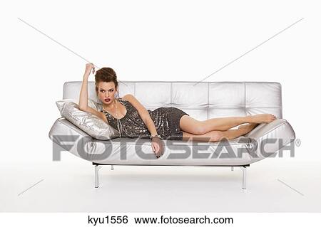 Young woman in formalwear lying on sofa View Large Photo Image Stock Photograph - Young woman in formalwear lying on sofa. Fotosearch