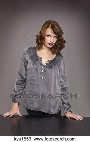 Stock Image - Young woman looking at camera. Fotosearch