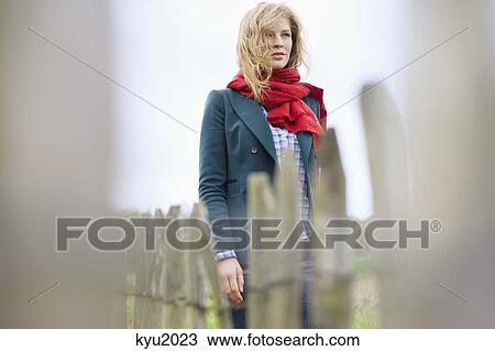 Beautiful woman standing in a field View Large Photo Image Stock Image - Beautiful woman standing in a field. Fotosearch