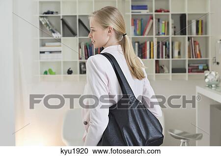 Stock Image - Businesswoman leaving for office. Fotosearch
