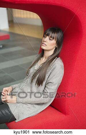 Stock Image - Close-up of a businesswoman looking pensive. Fotosearch