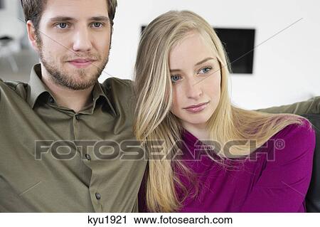 Stock Image - Close-up of a couple sitting together. Fotosearch