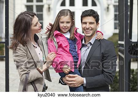 Close-up of a girl with her parents View Large Photo Image Stock Image - Close-up of a girl with her parents. Fotosearch