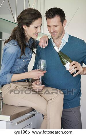 Couple drinking wine in the kitchen View Large Photo Image Stock Photography - Couple drinking wine in the kitchen. Fotosearch