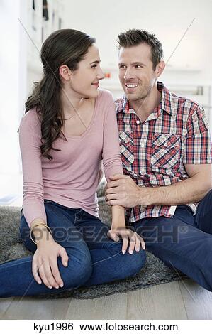 Stock Photograph - Couple smiling at each other. Fotosearch