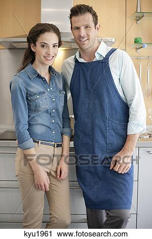 Couple standing together in the kitchen View Large Photo Image Stock Image - Couple standing together in the kitchen. Fotosearch