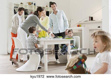 Stock Image - Family at the dining table with guests. Fotosearch