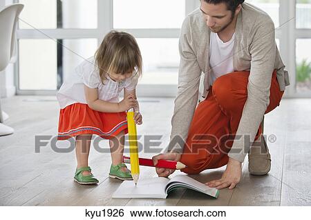 Stock Photograph - Man and daughter writing with big pencils. Fotosearch
