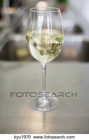 White wine in a wineglass View Large Photo Image Stock Image - White wine in a wineglass. Fotosearch