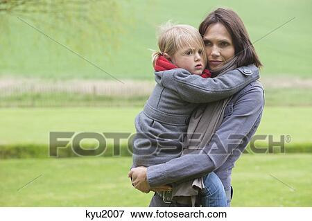Woman carrying her daughter View Large Photo Image Stock Photo - Woman carrying her daughter. Fotosearch