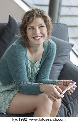 Woman checking her pregnancy View Large Photo Image Stock Image - Woman checking her pregnancy. Fotosearch