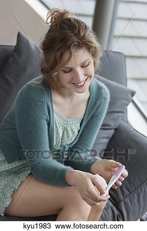 Woman checking her pregnancy View Large Photo Image Stock Image - Woman checking her pregnancy. Fotosearch