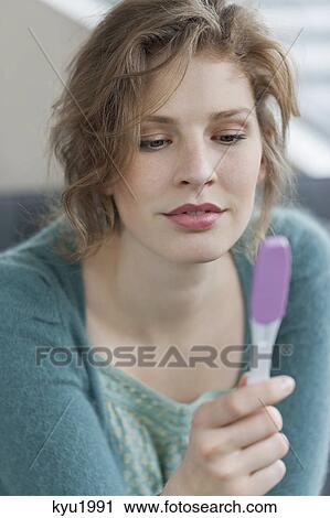 Stock Image - Woman checking her pregnancy. Fotosearch