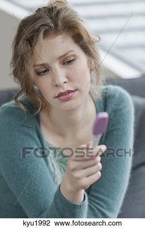 Woman checking her pregnancy View Large Photo Image Stock Image - Woman checking her pregnancy. Fotosearch