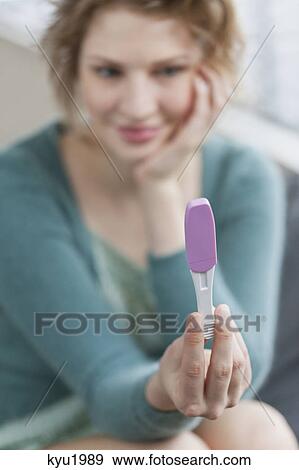 Stock Photo - Woman checking her pregnancy. Fotosearch