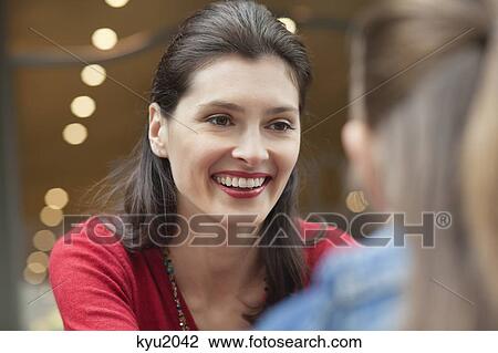 Woman looking at her daughter and smiling View Large Photo Image Stock Image - Woman looking at her daughter and smiling. Fotosearch