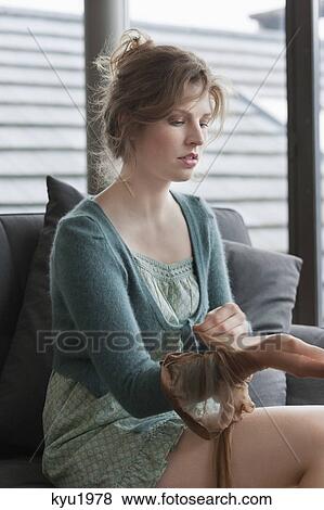 Stock Photo - Woman putting on stockings. Fotosearch