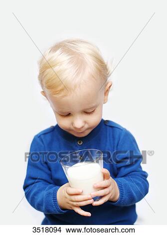 2 years old boy drinking a glass of milk View Large Photo Image Picture - 2 years old boy drinking a glass of milk. Fotosearch