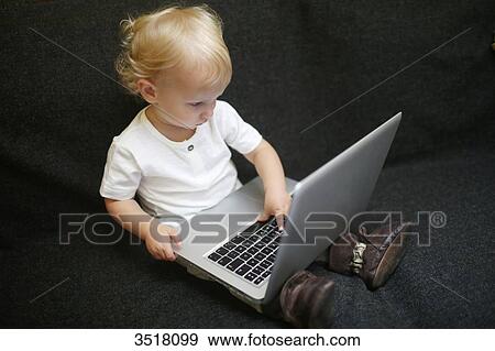 2 years old boy playing with a computer View Large Photo Image Stock Photo - 2 years old boy playing with a computer. Fotosearch