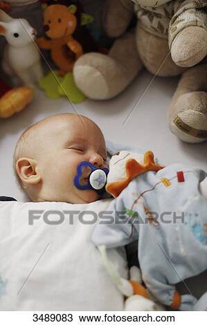 Stock Image - 8 months baby boy asleep. Fotosearch