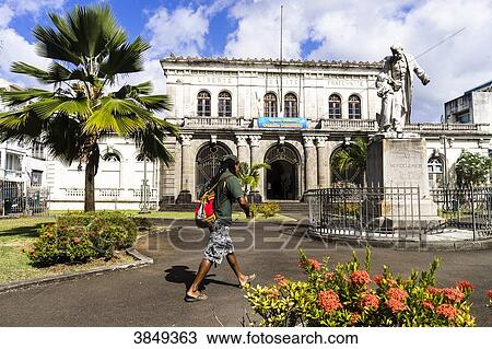 A black man is walking on the Camille Darsiere's place, Fort-de-France, Martinique, France View Large Photo Image Stock Image - A black man is walking on the Camille Darsiere's place, Fort-de-France, Martinique, France. Fotosearch