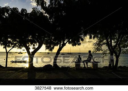 A father and his son sitted in front of the sunset, Saint-Louis, Marie-Galante, Guadeloupe, France View Large Photo Image Stock Photo - A father and his son sitted in front of the sunset, Saint-Louis, Marie-Galante, Guadeloupe, France. Fotosearch