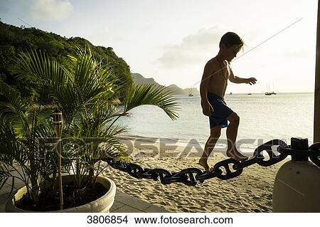 A kid of 7 years old is climbing on a chain, Bequia, Saint-Vincent and the Grenadines, West Indies View Large Photo Image Picture - A kid of 7 years old is climbing on a chain, Bequia, Saint-Vincent and the Grenadines, West Indies. Fotosearch