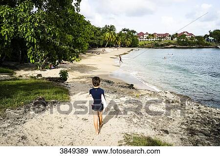 A kid walking on the Mabouya's beach, Sainte-Luce, Martinique, France View Large Photo Image Stock Photo - A kid walking on the Mabouya's beach, Sainte-Luce, Martinique, France. Fotosearch