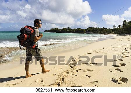 A man is walking alone on the Moustique's beach, Saint-Louis, Marie-Galante, Guadeloupe, France View Large Photo Image Stock Image - A man is walking alone on the Moustique's beach, Saint-Louis, Marie-Galante, Guadeloupe, France. Fotosearch
