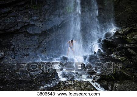 Stock Photo - A man under the Concord waterfall, Grenada, West Indies. Fotosearch