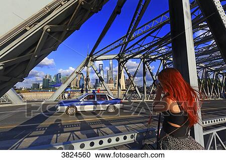 Asia, China, Shanghai. Photographer and taxi on Waibaidu bridge View Large Photo Image Stock Image - Asia, China, Shanghai. Photographer and taxi on Waibaidu bridge. Fotosearch