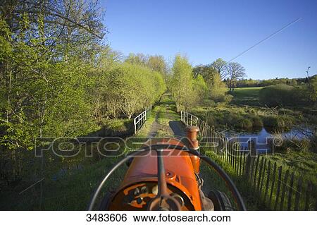 At the wheel of a tractor View Large Photo Image Stock Photograph - At the wheel of a tractor. Fotosearch