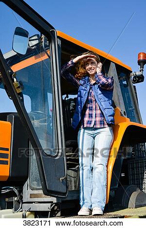 beautiful and cheerful young woman farmer driving tractor in the fields during harvest in countryside- Cepage Grenache, View Large Photo Image Stock Image - beautiful and cheerful young woman farmer driving tractor in the fields during harvest in countryside- Cepage Grenache,. Fotosearch