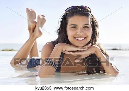 Beautiful woman lying on the beach View Large Photo Image Stock Image - Beautiful woman lying on the beach. Fotosearch