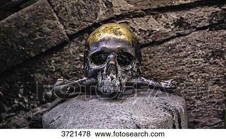 Stock Photo - Black Skull bronze marks the entrance to the church of the Souls in Purgatory - Province of Naples, Campania, Italy. Fotosearch