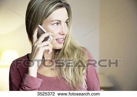 Blond woman using phone View Large Photo Image Stock Image - Blond woman using phone. Fotosearch