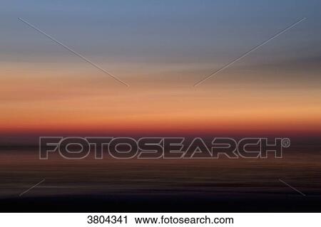 Stock Image - Blurred seascape at dusk.. Fotosearch