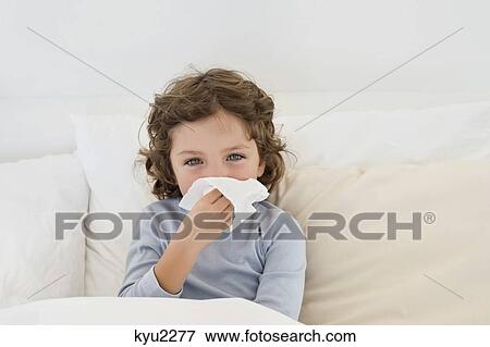 Stock Photo - Boy suffering from cold. Fotosearch