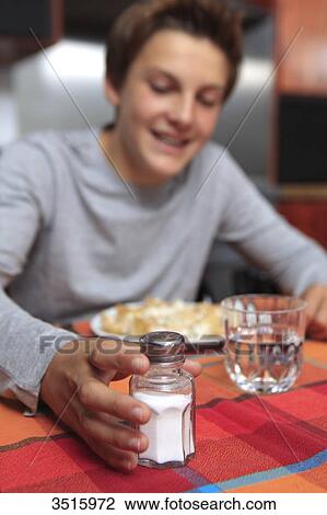 Boy using saltshaker View Large Photo Image Stock Image - Boy using saltshaker. Fotosearch