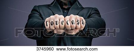 Stock Image - Businessman tattooed fists. Fotosearch