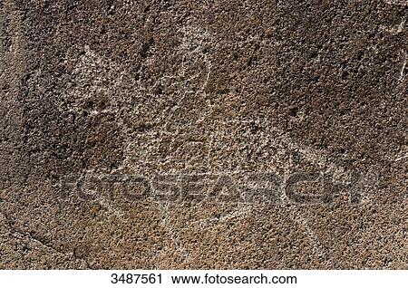 Stock Image - Central Asia, Kyrgyzstan, Issyk Kul Province (Ysyk-Kl), Issyk Kul Lake, Cholpon Ata, petroglyph depicting a hunting scene. Fotosearch