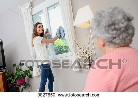 Cheerful young girl helping with household chores elderly woman at home. View Large Photo Image Stock Image - Cheerful young girl helping with household chores elderly woman at home.. Fotosearch