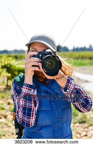 cheerful young woman hiking and taking pictures with her reflex single lens camera- Cepage Grenache, Chateauneuf du Pape, cotes du Rhone, France View Large Photo Image Stock Photo - cheerful young woman hiking and taking pictures with her reflex single lens camera- Cepage Grenache, Chateauneuf du Pape, cotes du Rhone, France. Fotosearch